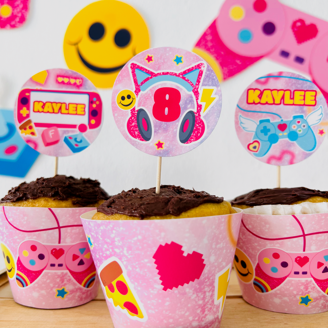 Cupcakes with personalised pink gamer girl themed toppers and pink wrappers