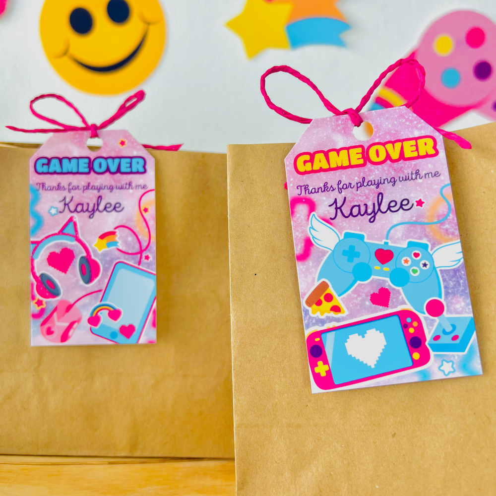 Printable pink gamer girl favor tags mockup tied on bags for birthday party favors