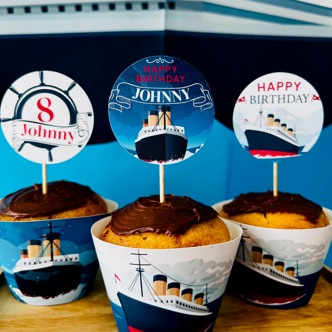 Cupcakes with Titanic-themed toppers and wrappers on a blue background