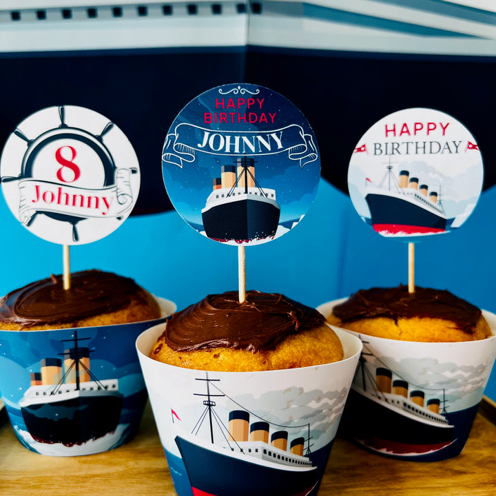 Cupcakes with Titanic-themed toppers and wrappers on a blue background