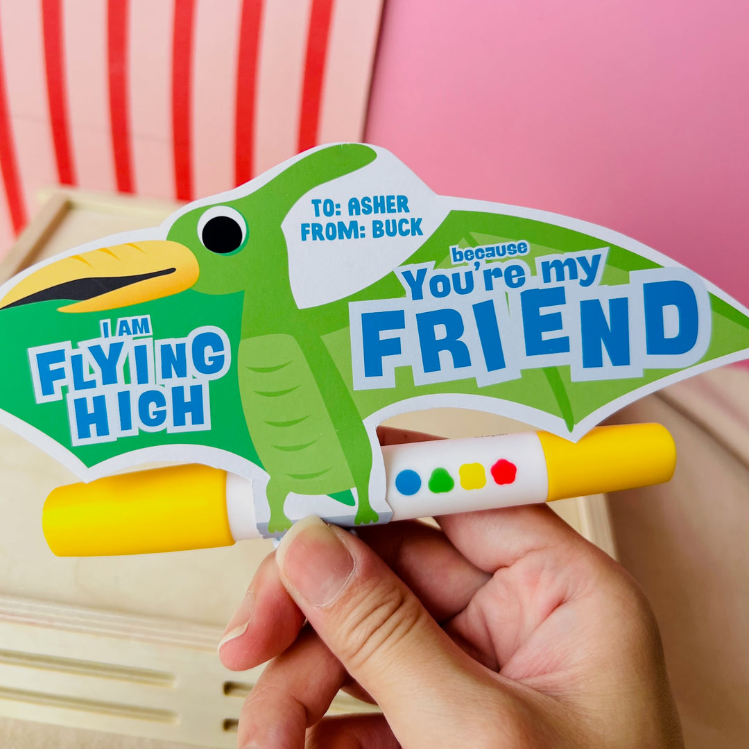 Green printable pterodactyl gift card holder saying "You're My Flying Friend" with marker for classroom gift exchanges