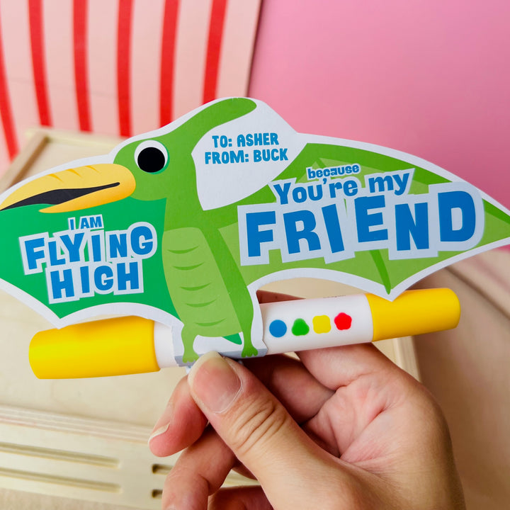 Green printable pterodactyl gift card holder saying "You're My Flying Friend" with marker for classroom gift exchanges