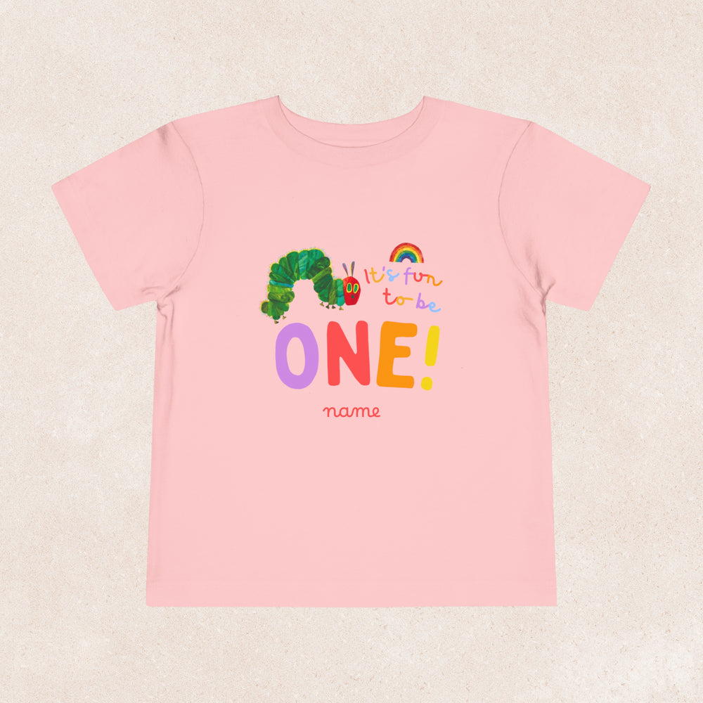 A personalised Very Hungry Caterpillar birthday shirt in pink featuring texts 'It's Fun to be One!'