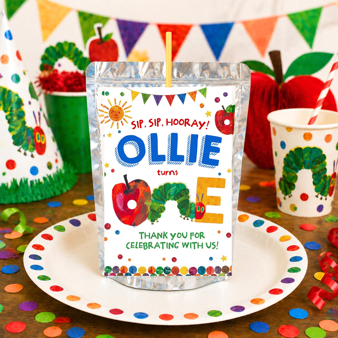 Editable Very Hungry Caterpillar Capri Sun pouch label template for first birthday parties featuring “Ollie Turns One” personalized design on a juice pouch, displayed on a Eric Carle's caterpillar-themed dessert table with party decorations and Canva editable badge.
