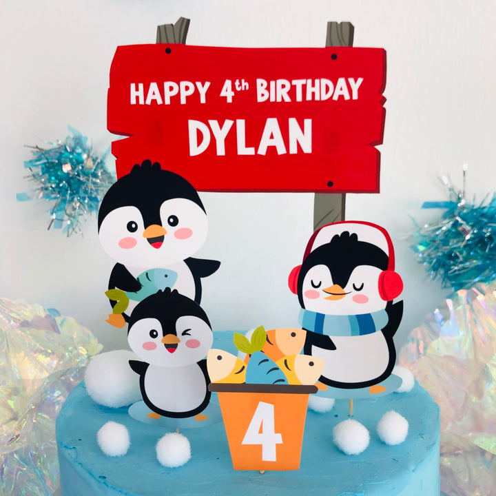 Penguin cake topper with birthday sign and fish